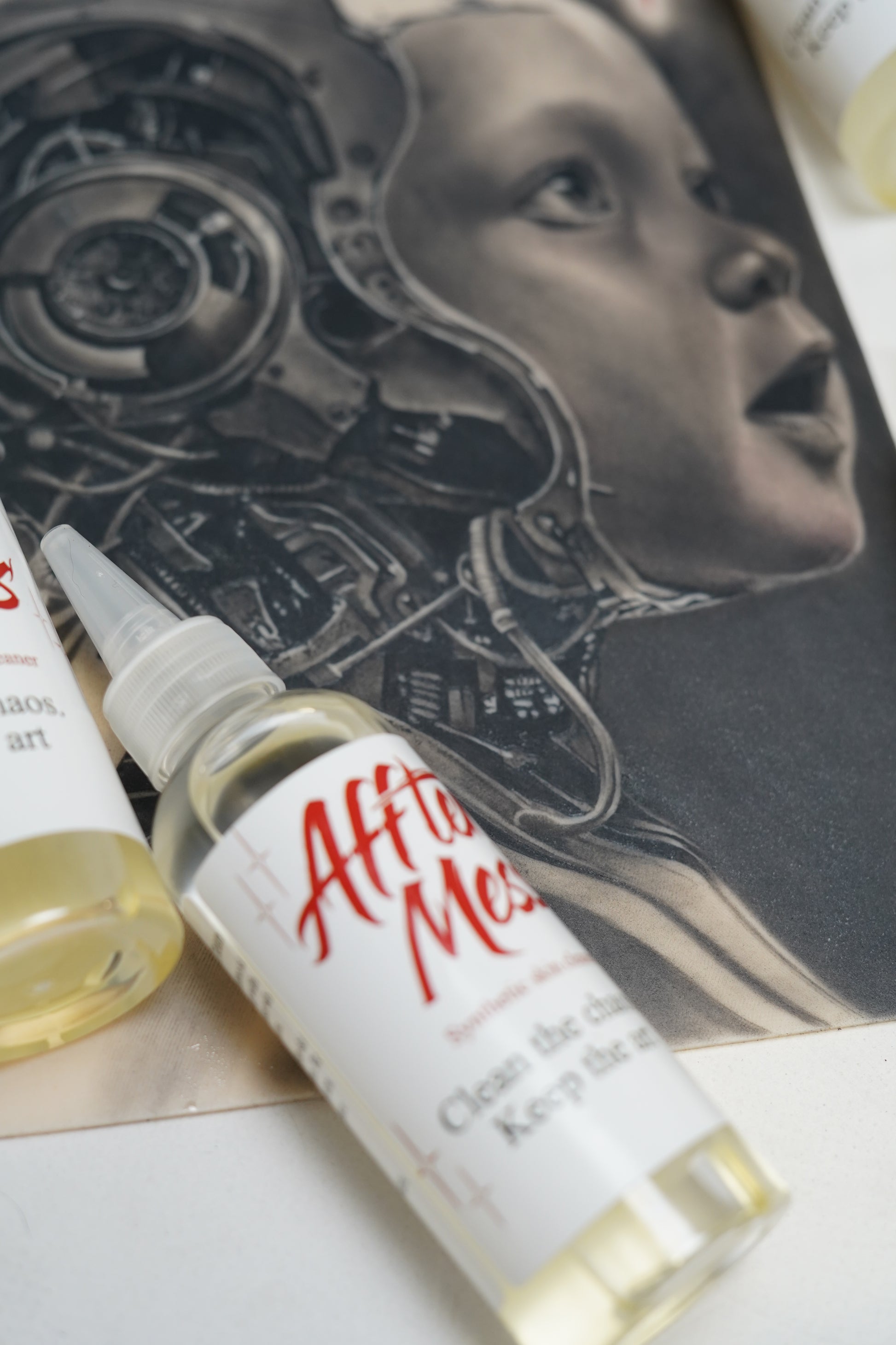 Bottle of after-meck brand after-shave on a surface with a mechanical design in the background